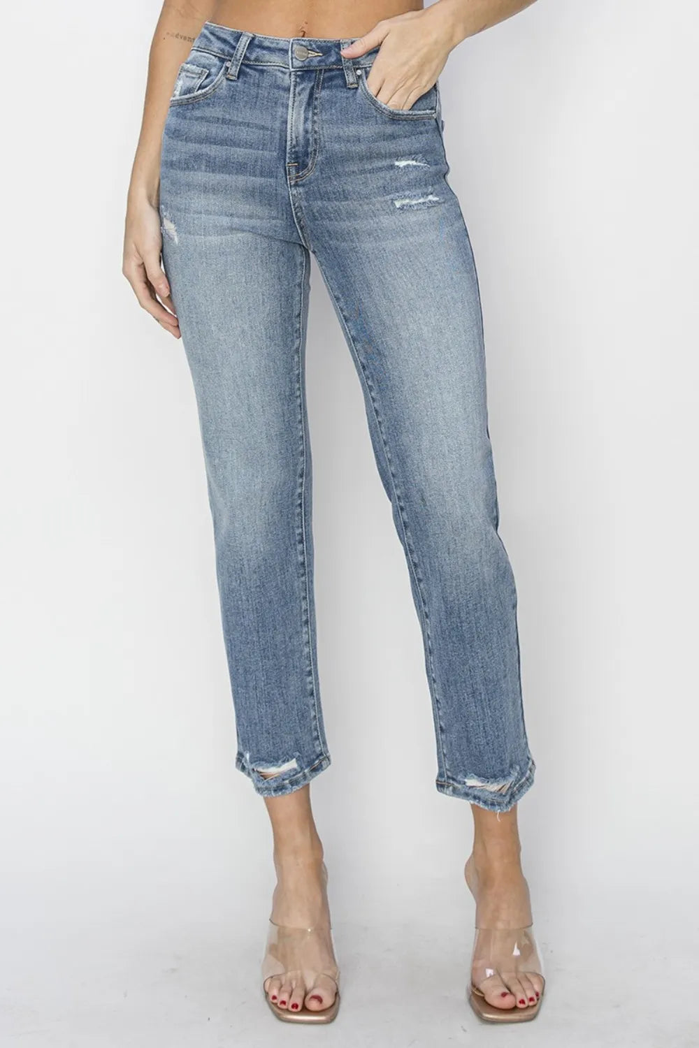 Person wearing light blue jeans on a white background