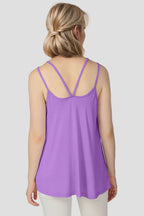 Woman wearing a purple tank top on a plain background