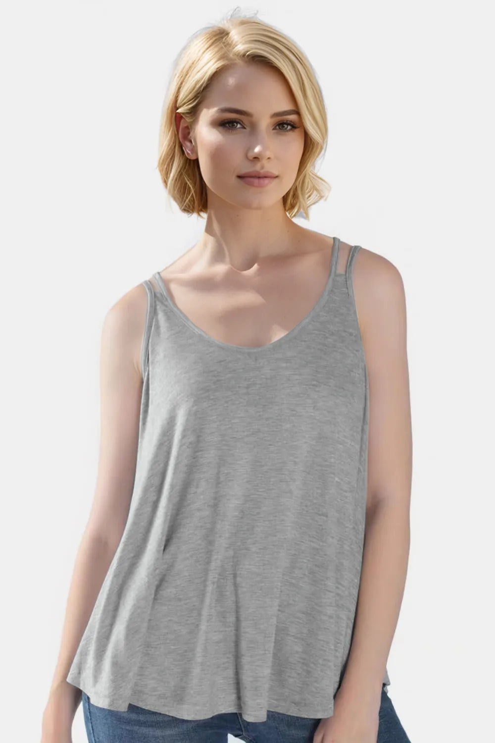 Woman wearing a gray tank top against a white background