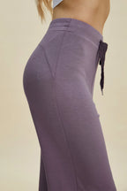 Purple pants with a beige background