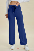 Blue pants worn by a person on a beige background