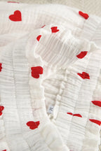 White fabric with red heart patterns