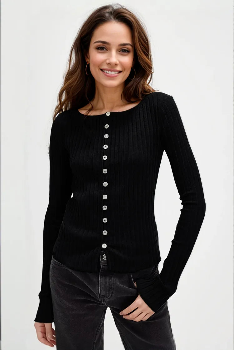 Woman wearing a black button-up cardigan against a white background