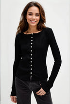 Woman wearing a black button-up cardigan against a white background