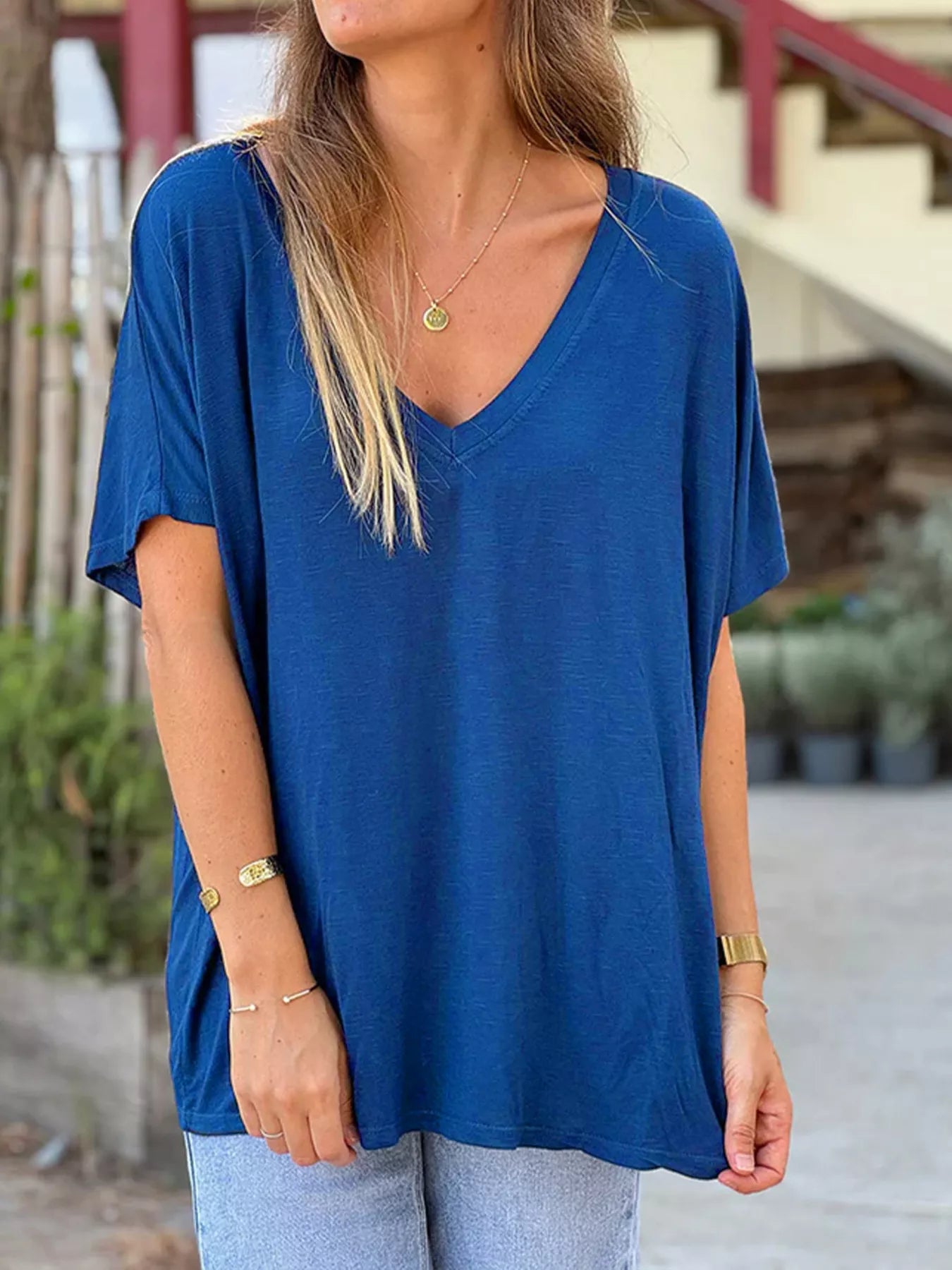 Woman wearing a blue oversized t-shirt with a blurred background