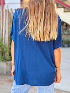 Person wearing a blue shirt with a blurred background