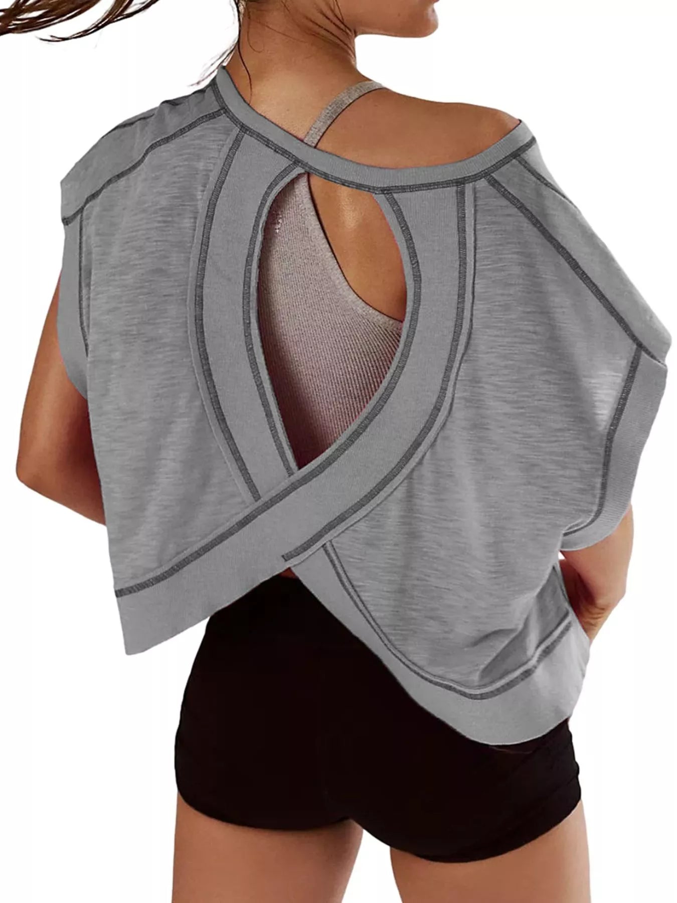 Gray open-back top worn by a person on a white background