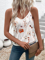Woman wearing a floral tank top and blue jeans, standing outdoors.