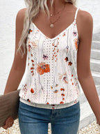 Woman wearing a floral print tank top with a white background