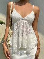 Woman wearing a white lace top against a neutral background