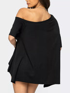 Black off-shoulder dress worn by a person on a white background