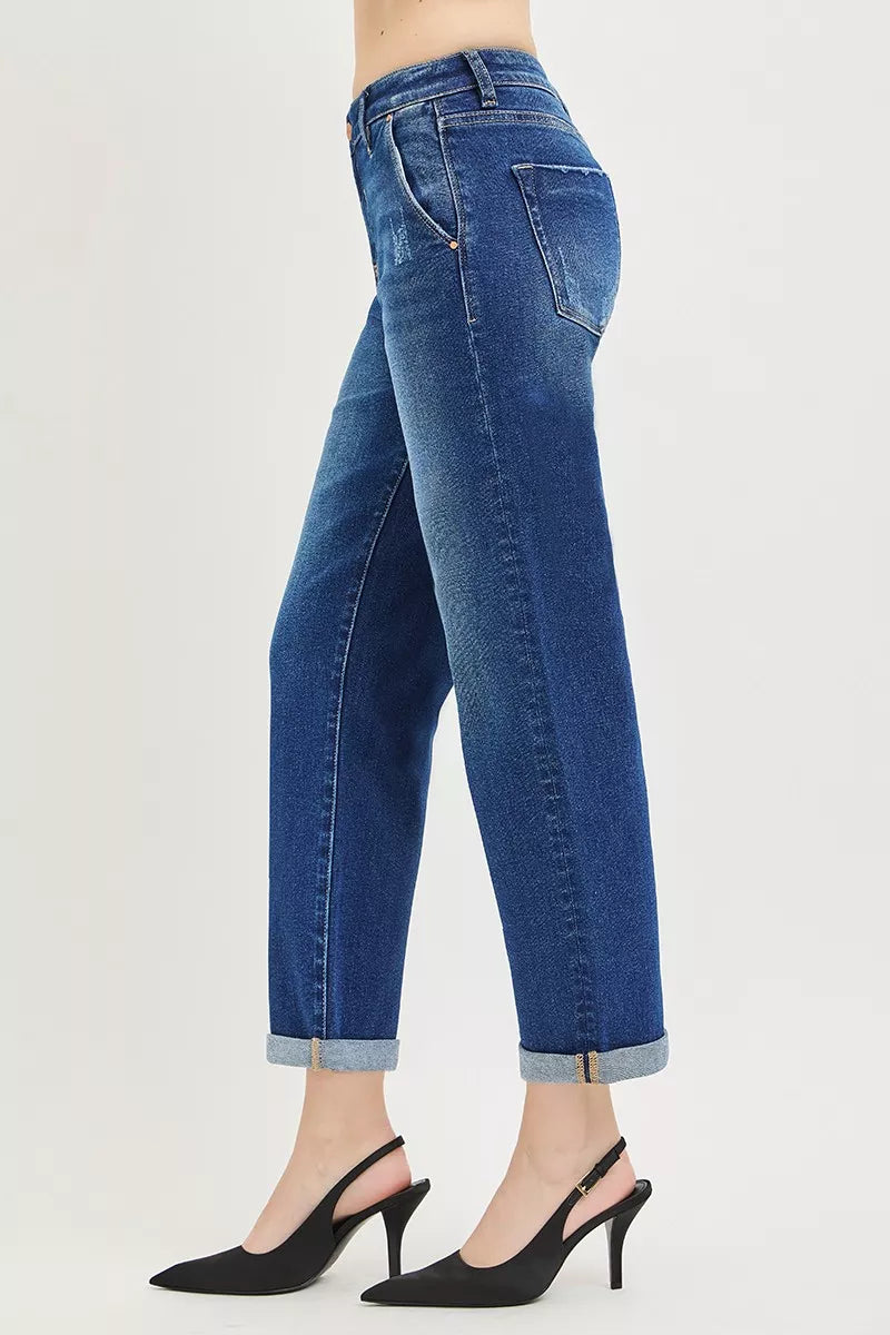 Blue jeans worn by a person on a light gray background