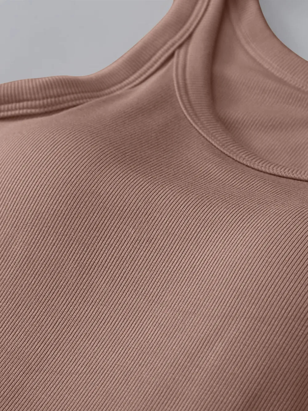 Close-up of a brown ribbed garment on a gray background