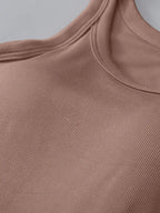 Close-up of a brown ribbed garment on a gray background