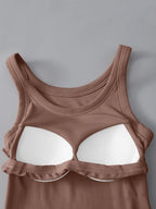 Brown tank top with white bra cups on a gray background