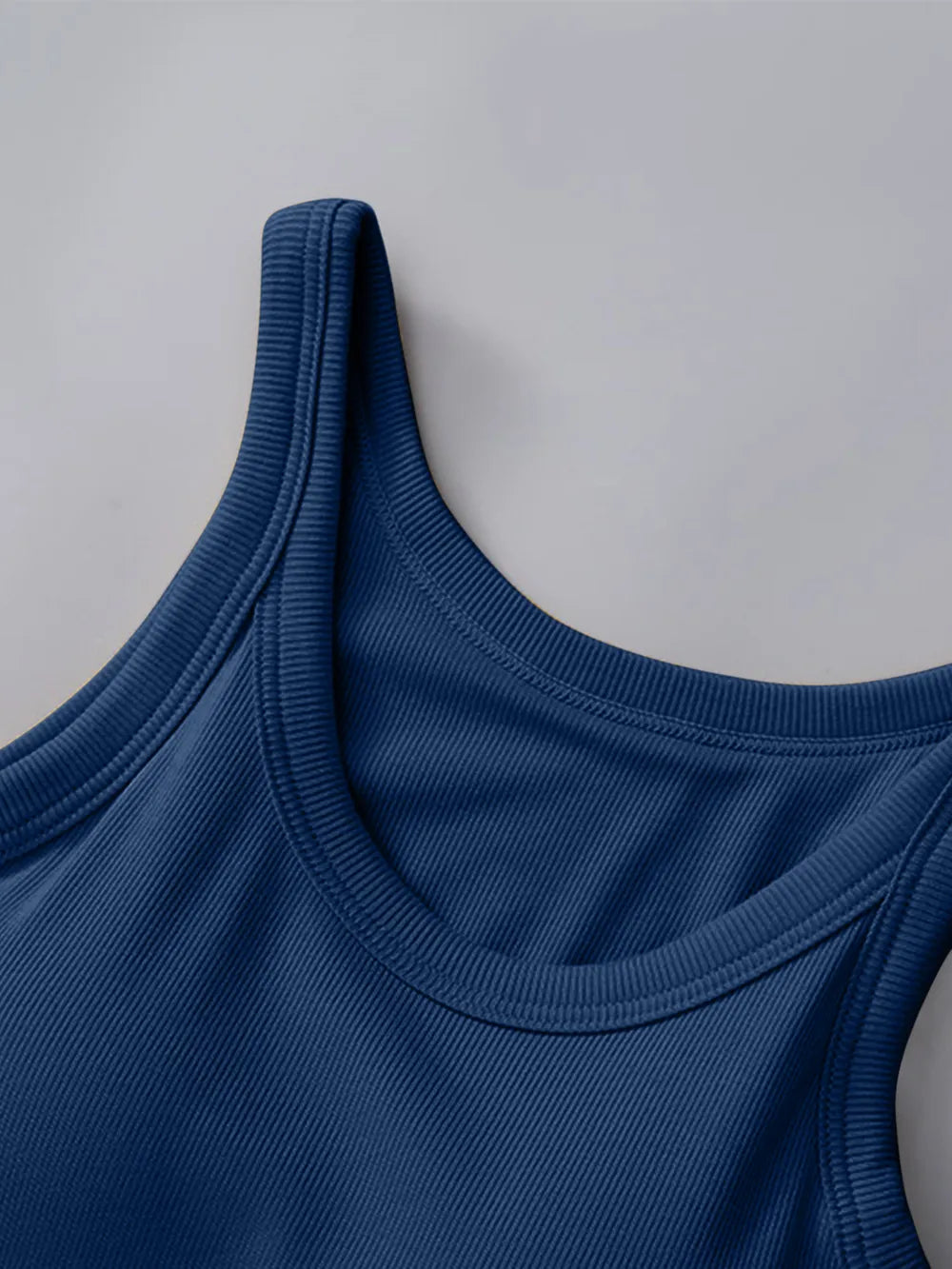 Close-up of a blue tank top on a light gray background