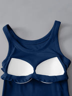 Blue tank top with white bra-like design on a gray background