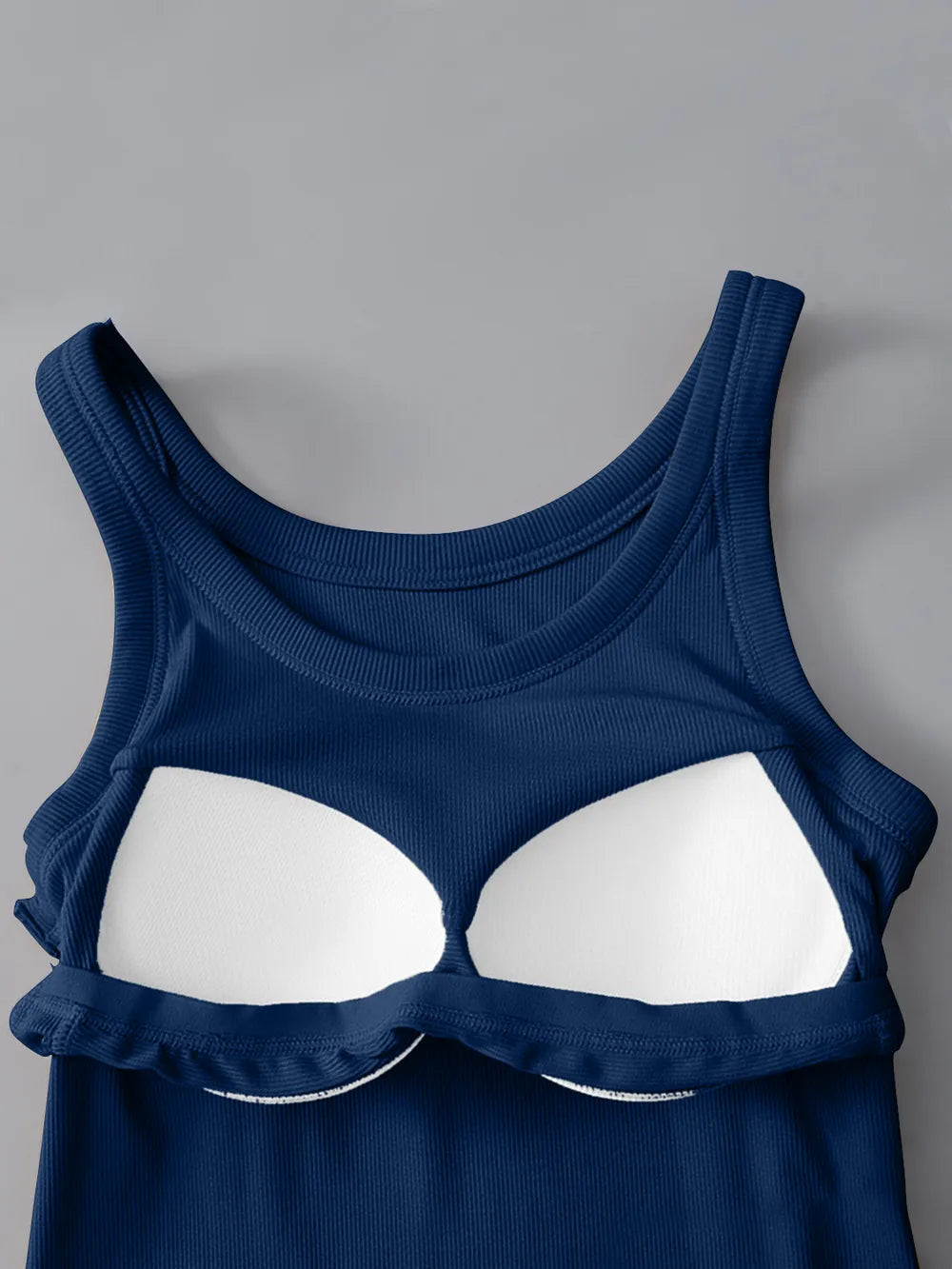 Blue tank top with white bra-like design on a gray background