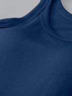 Close-up of a blue garment with a ribbed texture on a gray background