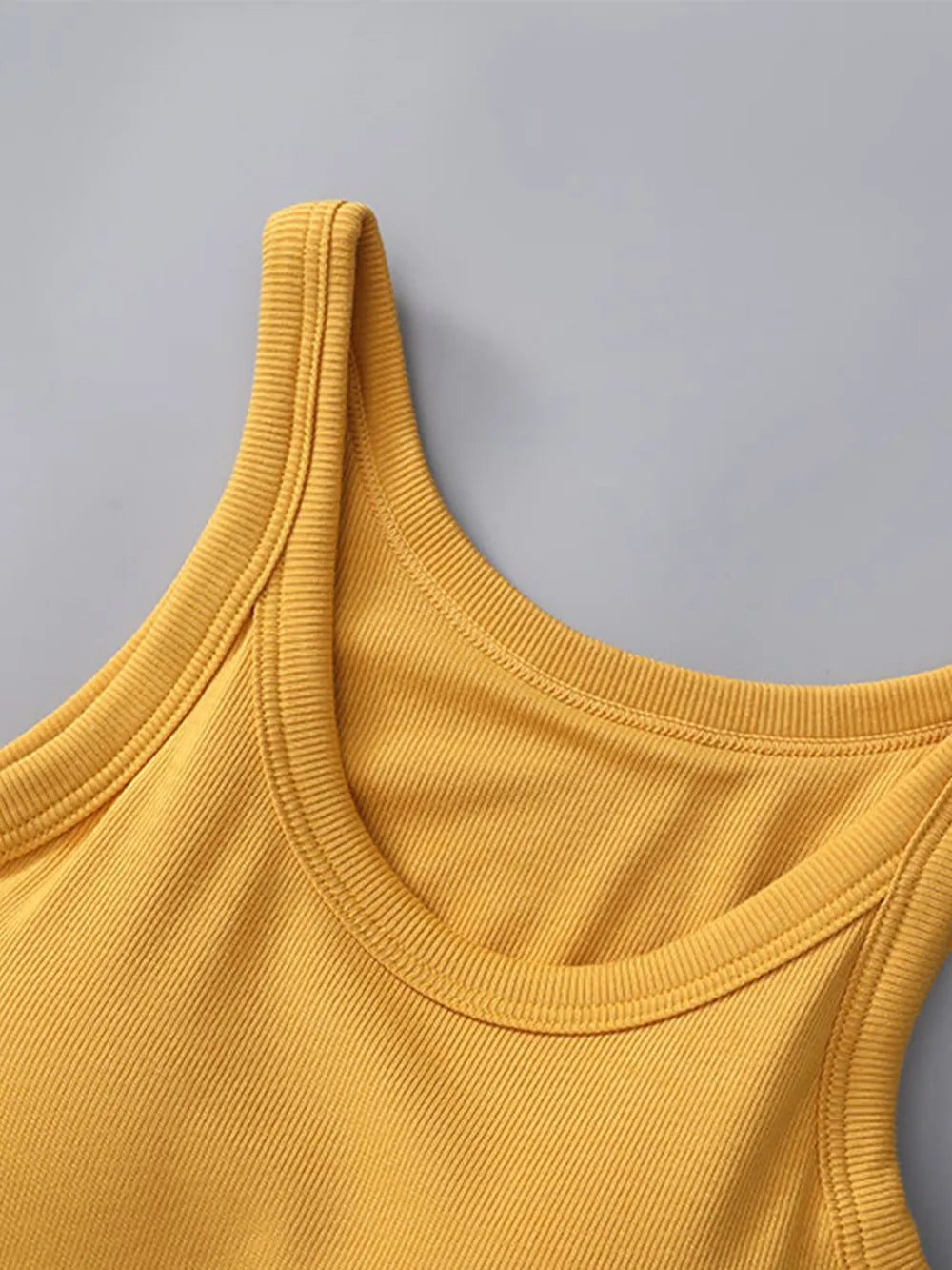 Yellow tank top on a gray background