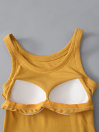 Yellow tank top with cut-out design on a gray background