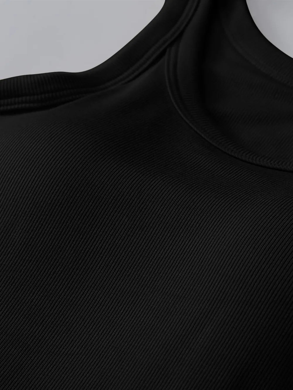 Close-up of a black sleeveless top with a plain background