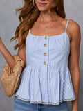 Woman wearing a blue striped dress with gold buttons against a gray background