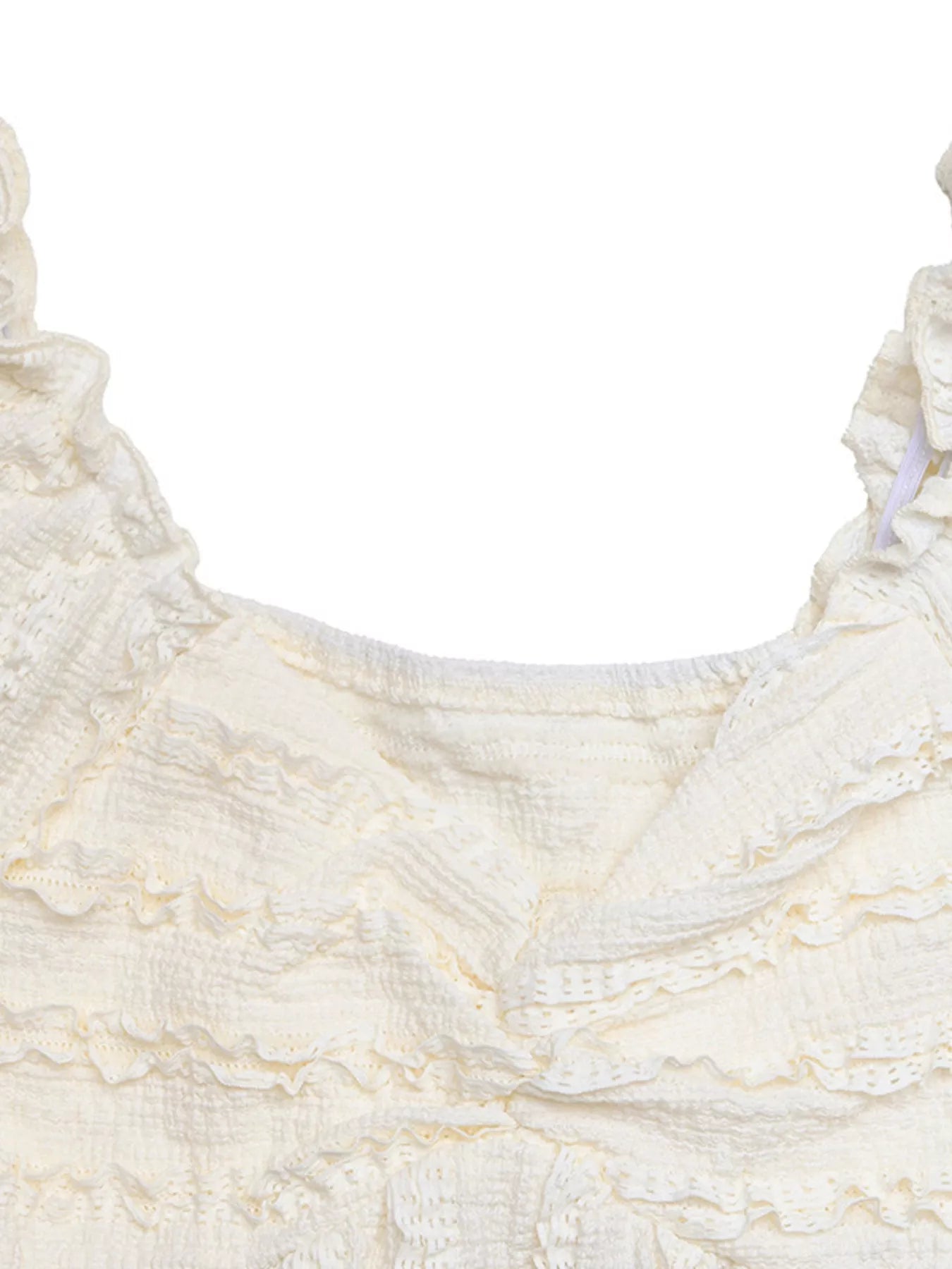 Close-up of a textured white fabric with ruffled edges on a white background