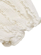 Close-up of a white lace fabric with ruffled edges on a white background
