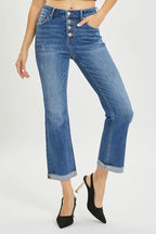 Person wearing blue jeans with a white background