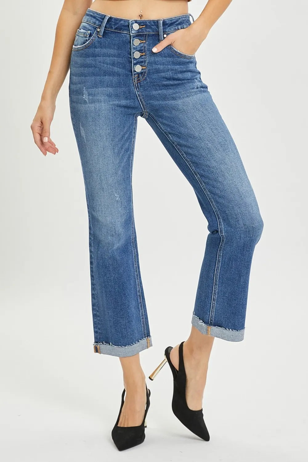 Person wearing blue jeans with a white background