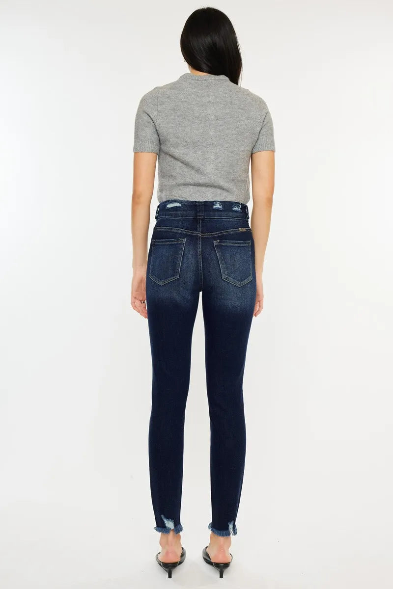 Person wearing dark blue jeans and a gray shirt on a white background