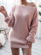 Pink off-shoulder sweater worn by a person indoors with a blurred background