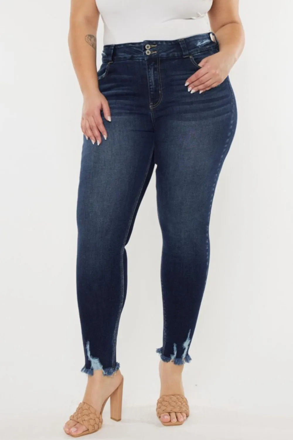 Person wearing dark blue jeans on a white background
