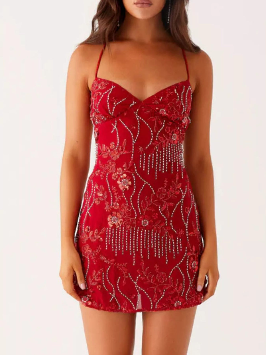 Red dress with floral patterns and embellishments on a white background