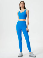 Woman wearing a blue athletic outfit on a white background