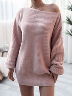 Person wearing a pink off-shoulder sweater in a bright room.