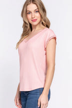 Woman wearing a pink top and blue jeans on a white background
