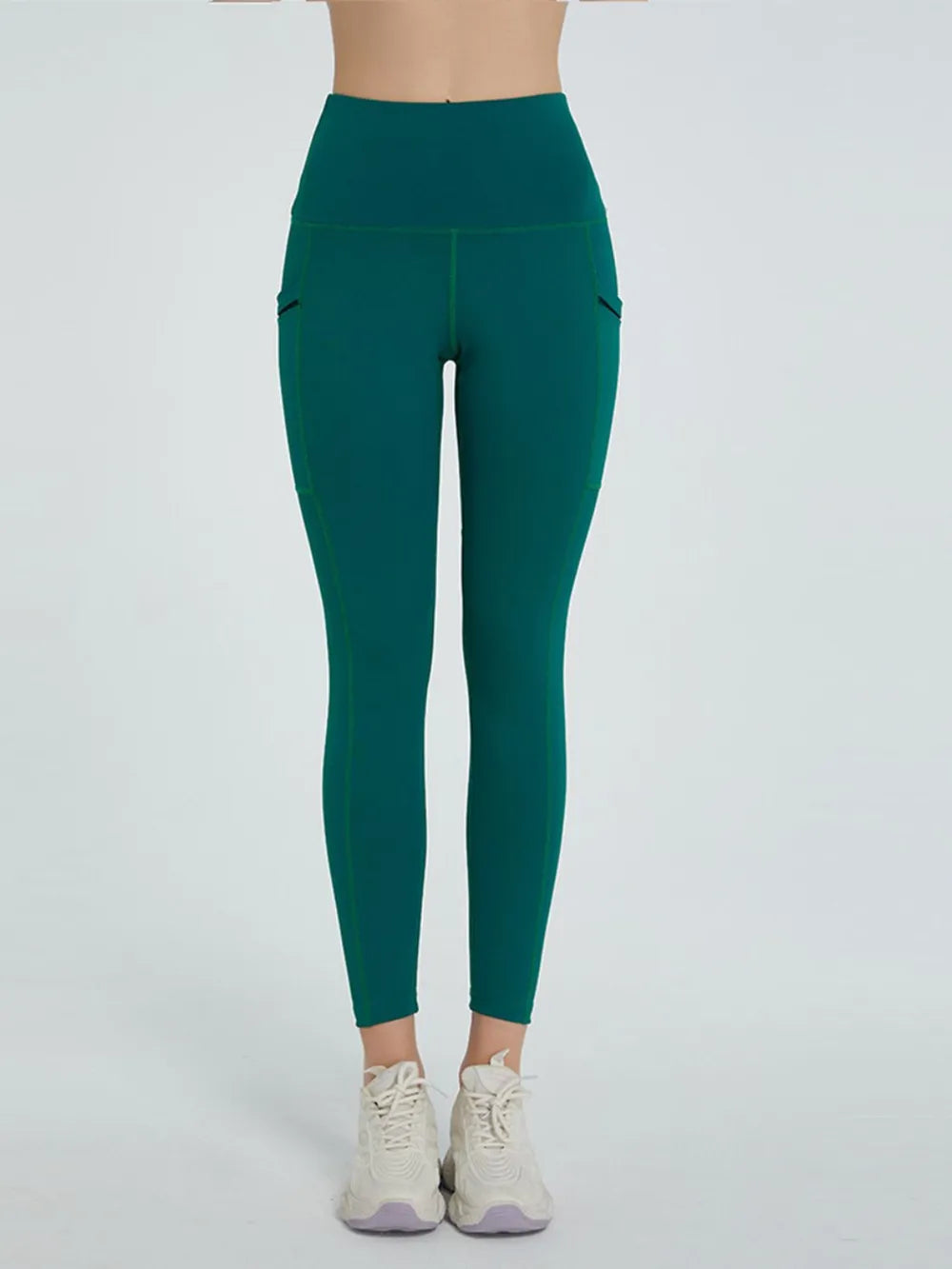 Green leggings worn by a person on a white background