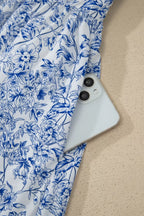 White phone with blue floral pattern on fabric