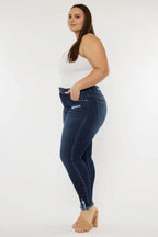 Woman wearing blue jeans and a white top on a white background