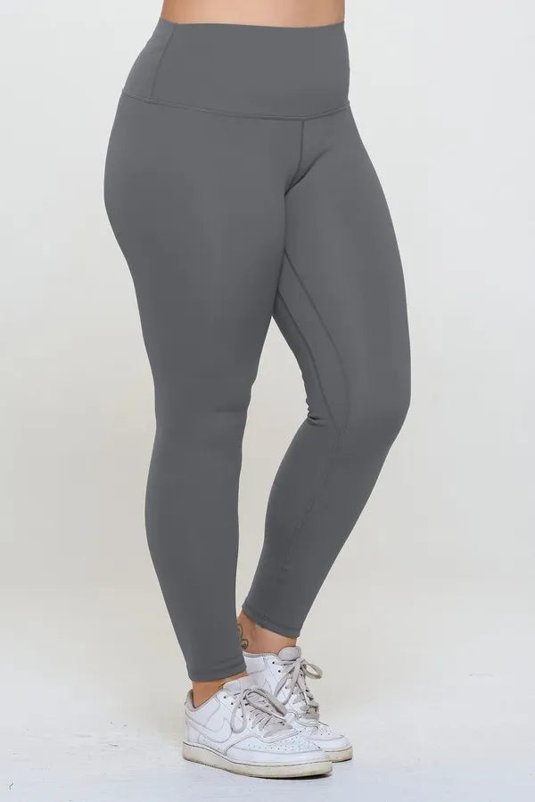 Gray leggings worn by a person on a white background