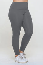 Gray leggings worn by a person on a white background