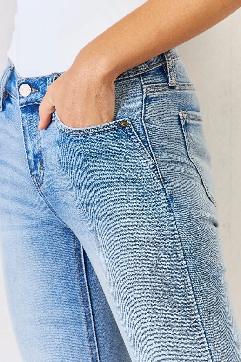 Light blue jeans worn by a person with a neutral background