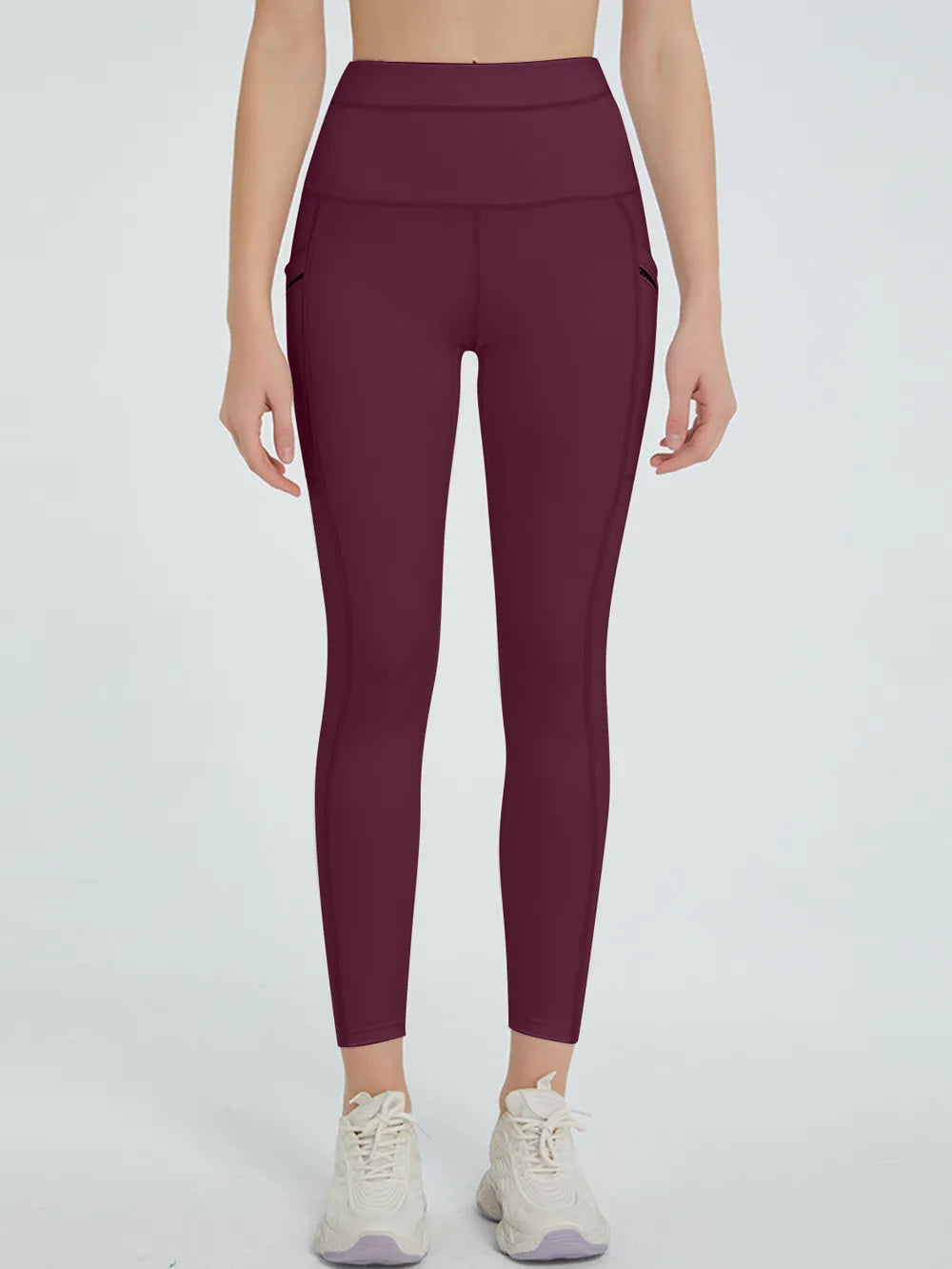 Maroon leggings worn by a person on a white background