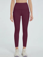 Maroon leggings worn by a person on a white background