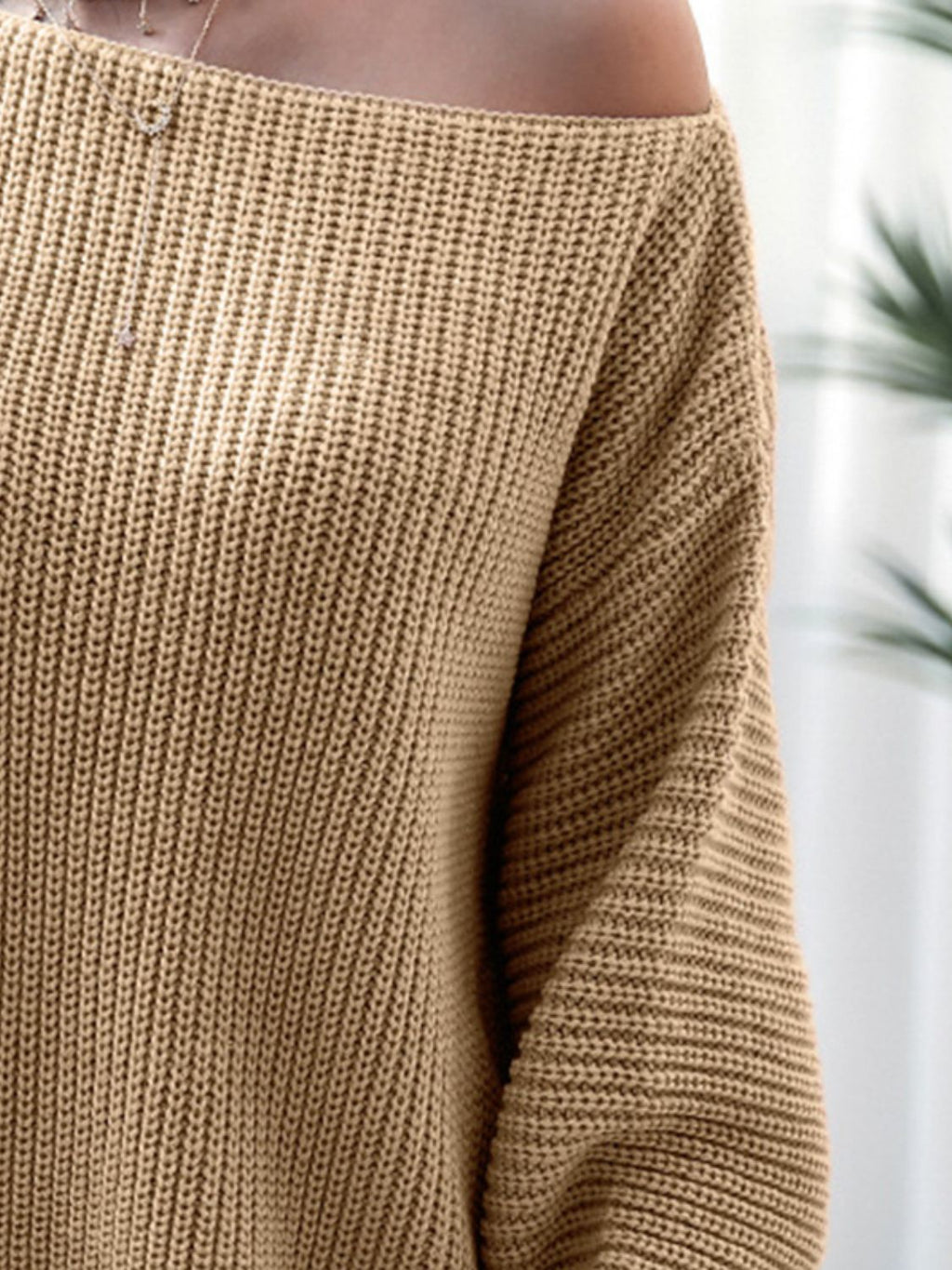 Close-up of a brown knitted sweater with a blurred background