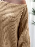 Close-up of a brown knitted sweater with a blurred background