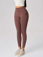 Brown leggings worn by a person on a white background