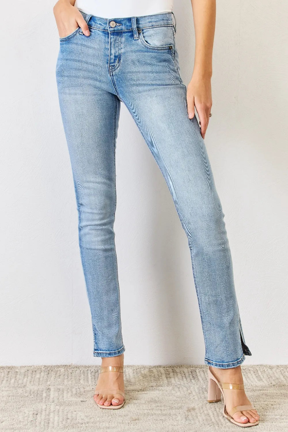 Light blue jeans worn by a person on a plain background